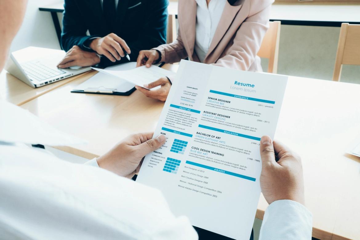 HR staff member reviewing a CV at a desk