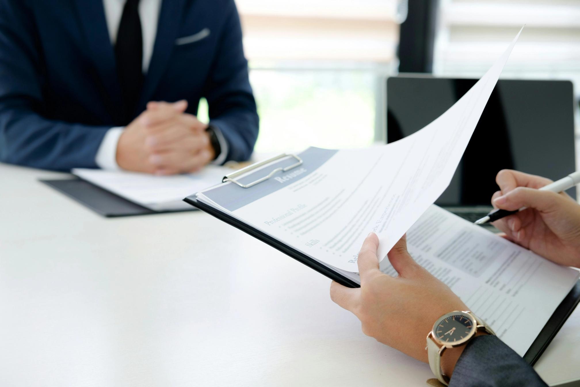 Man holding a resume in a job interview