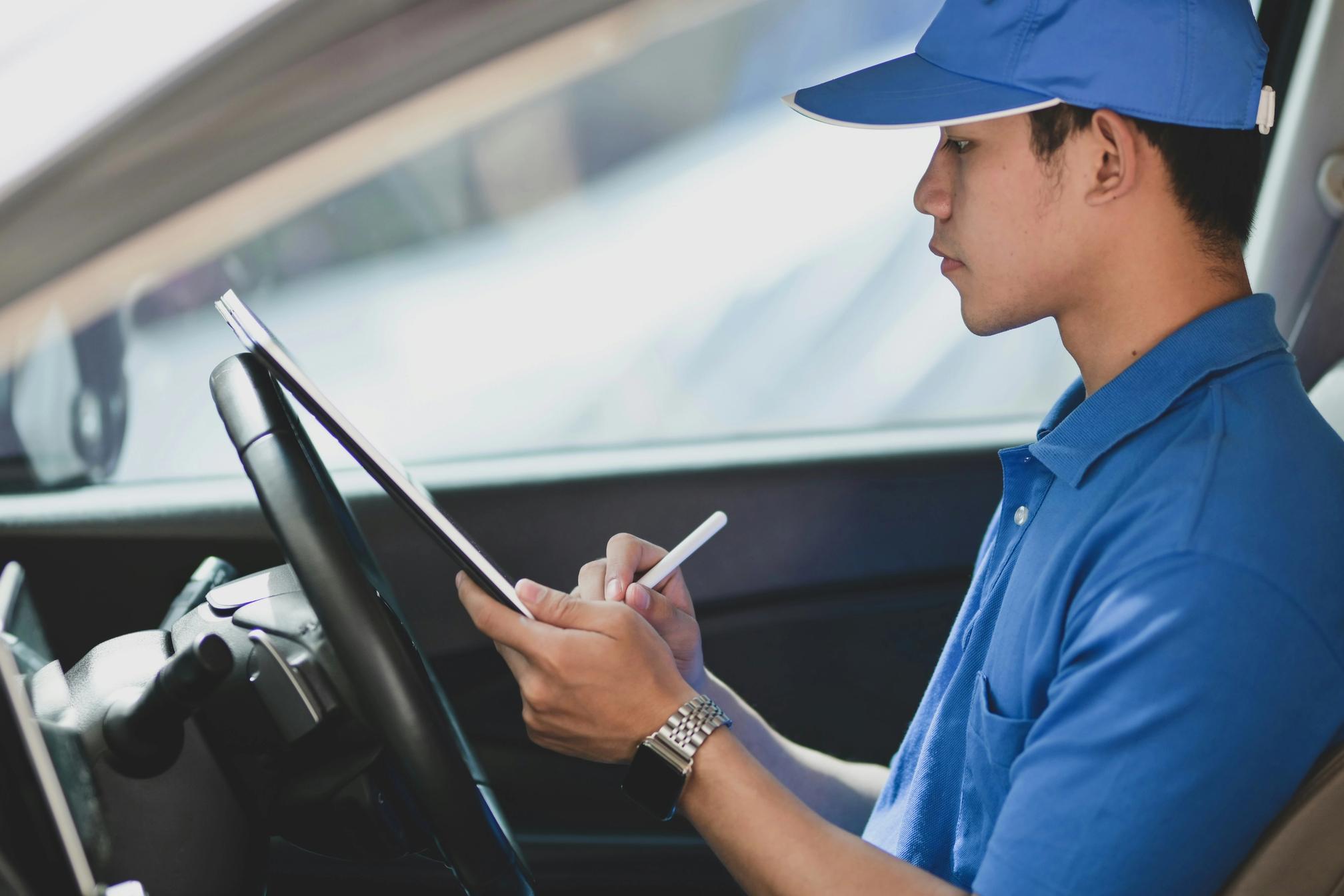 Courier driver holding a clipboard and pen