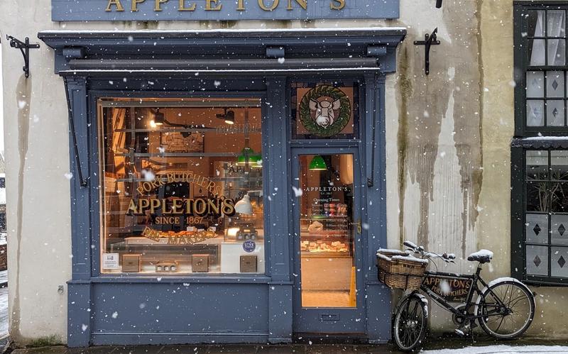 A local butcher shop on a snowy winter day.