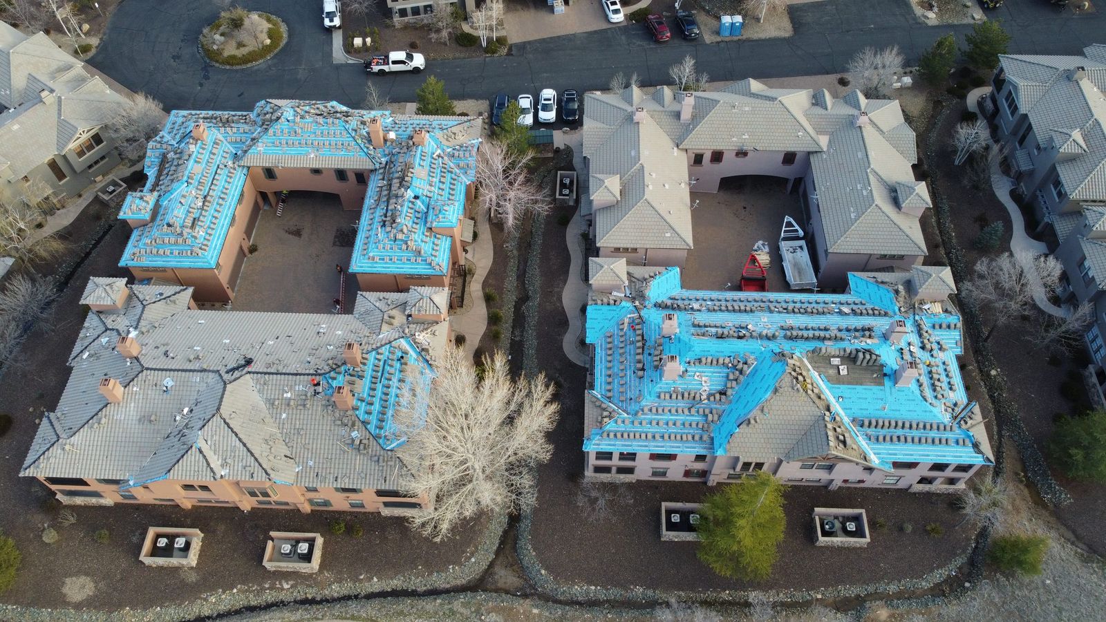 Two buildings mid re-roof, seen from above, Prescott, March 2023.