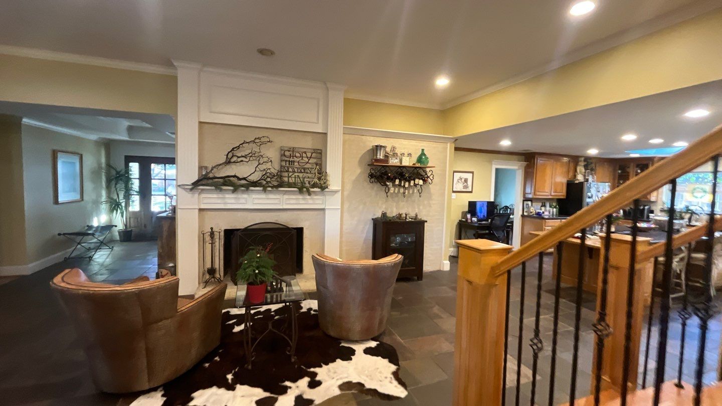 Living room before: a dark tile floor and a painted fireplace surround