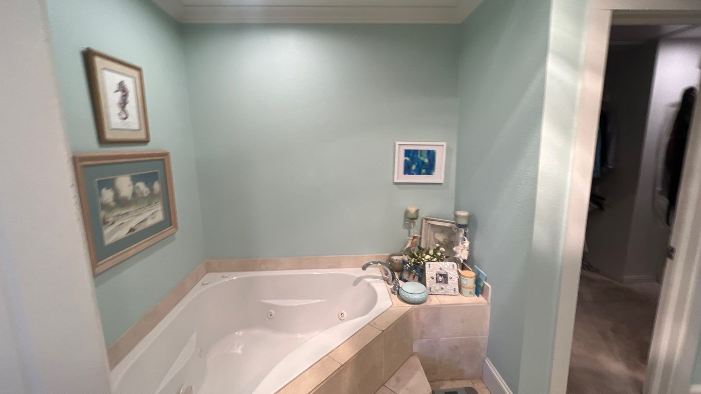 Corner tub before, set in a tiled deck