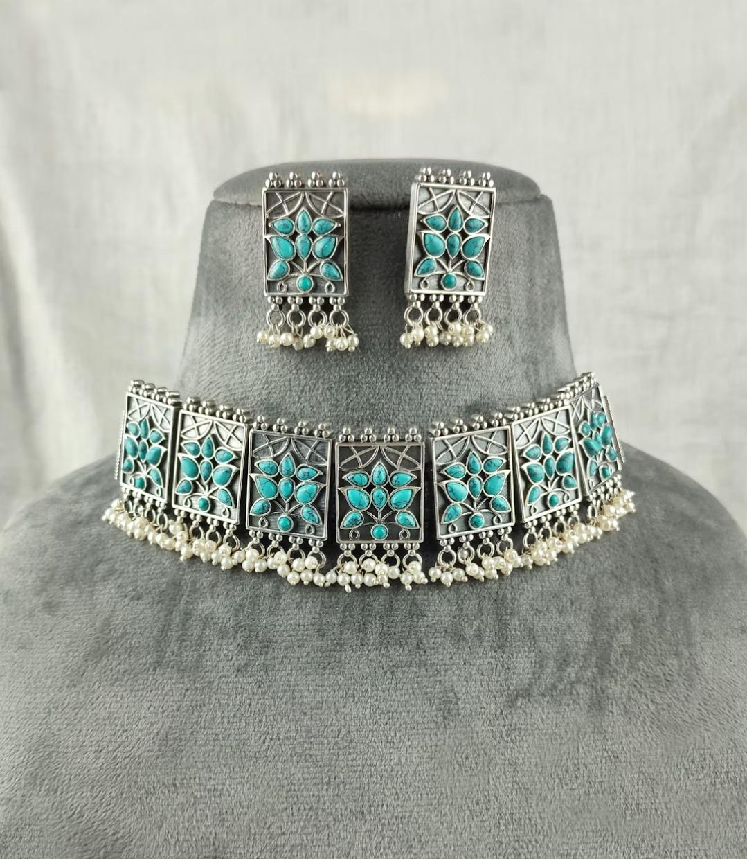 A necklace and earring set with turquoise stones