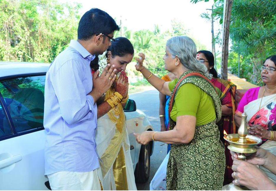 Elder applying tilak on the forehead