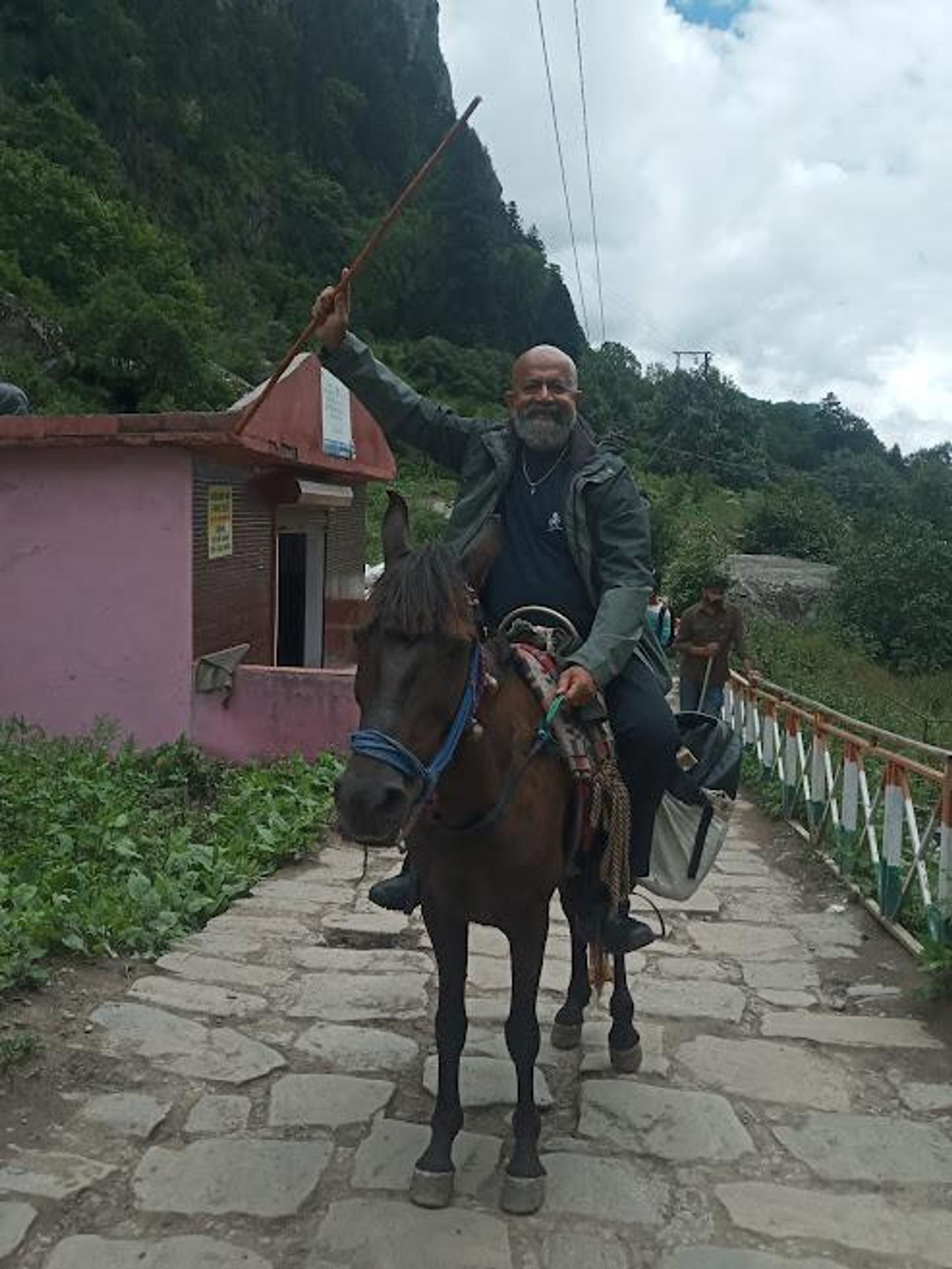 Happy man riding a mule
