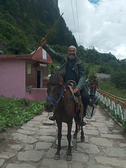 Happy man riding a mule
