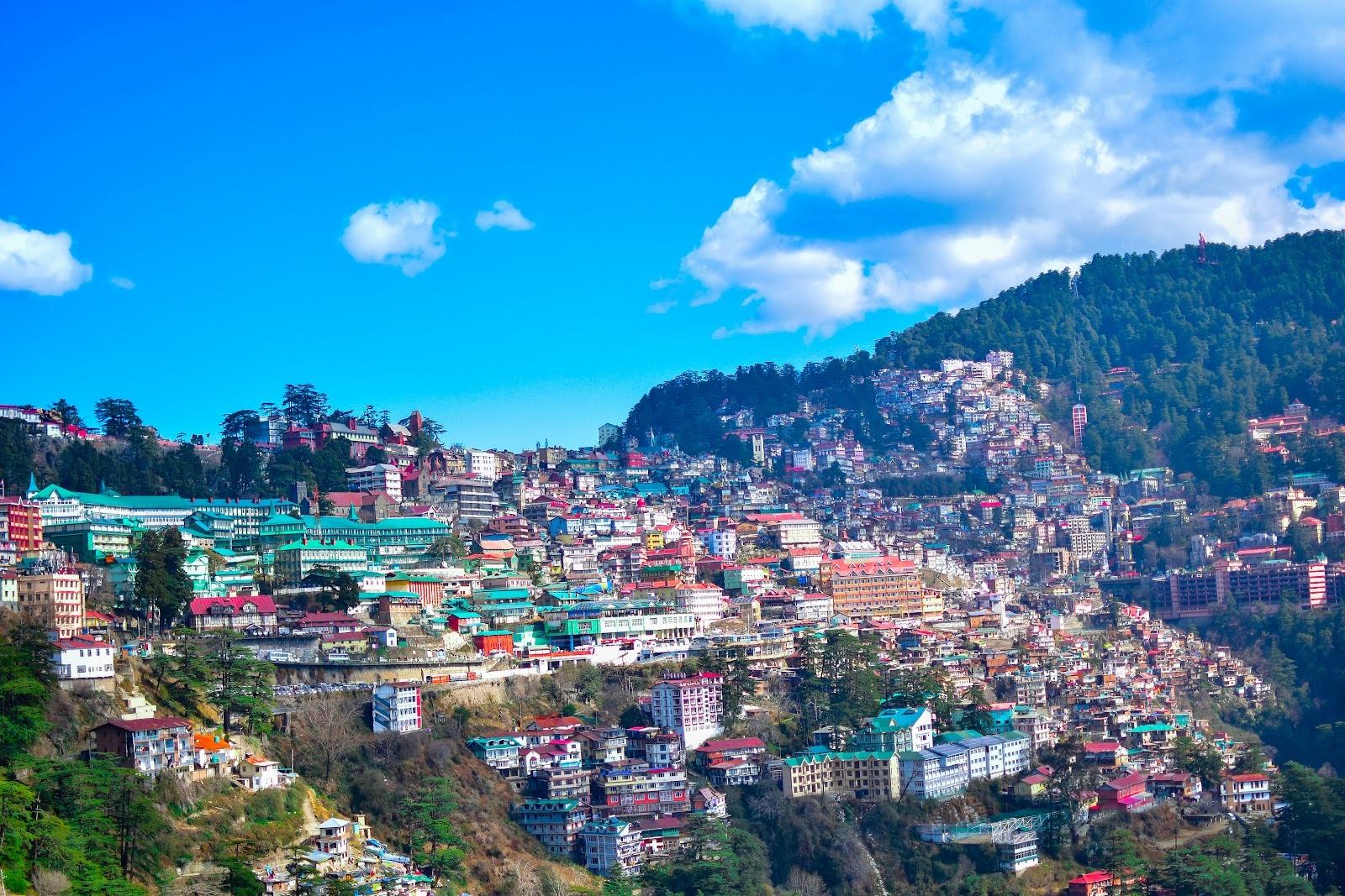Summer city near mountain under blue sky during daytime