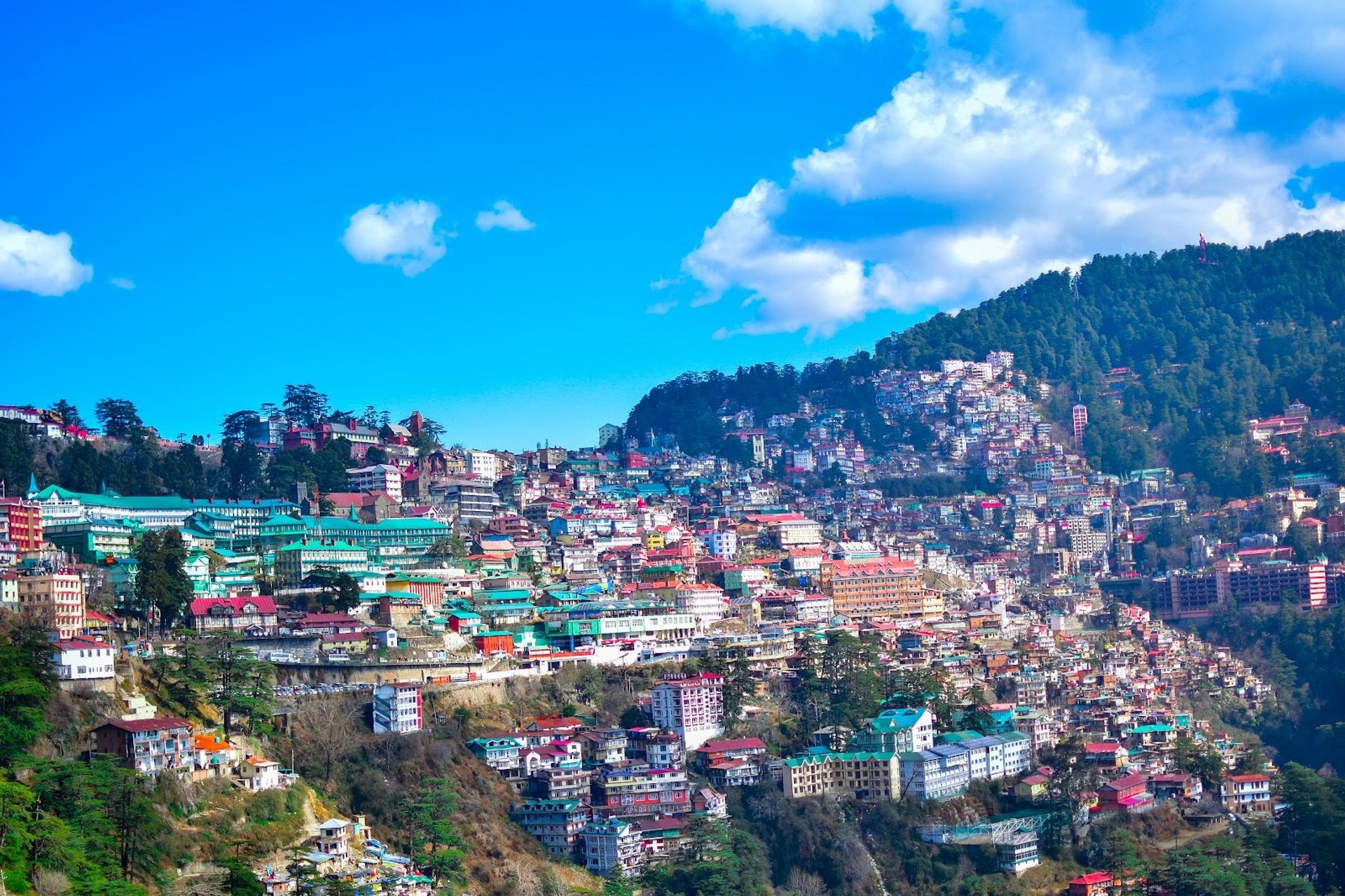 Summer city near mountain under blue sky during daytime