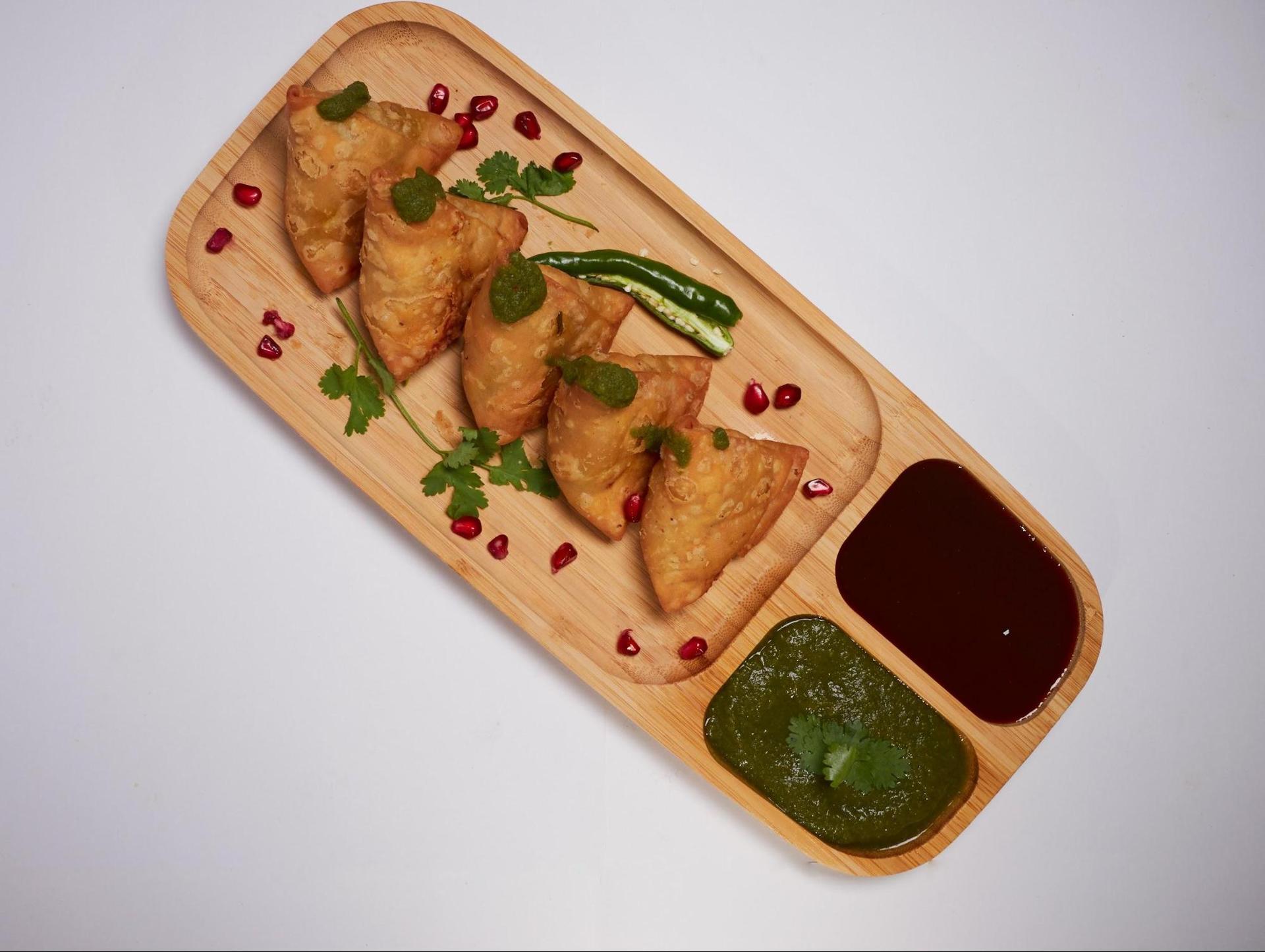 Plate of samosas with dips