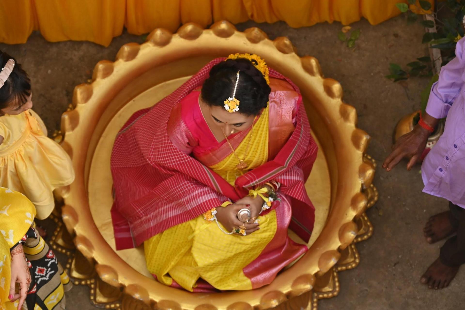 Woman wearing a red and gold sari