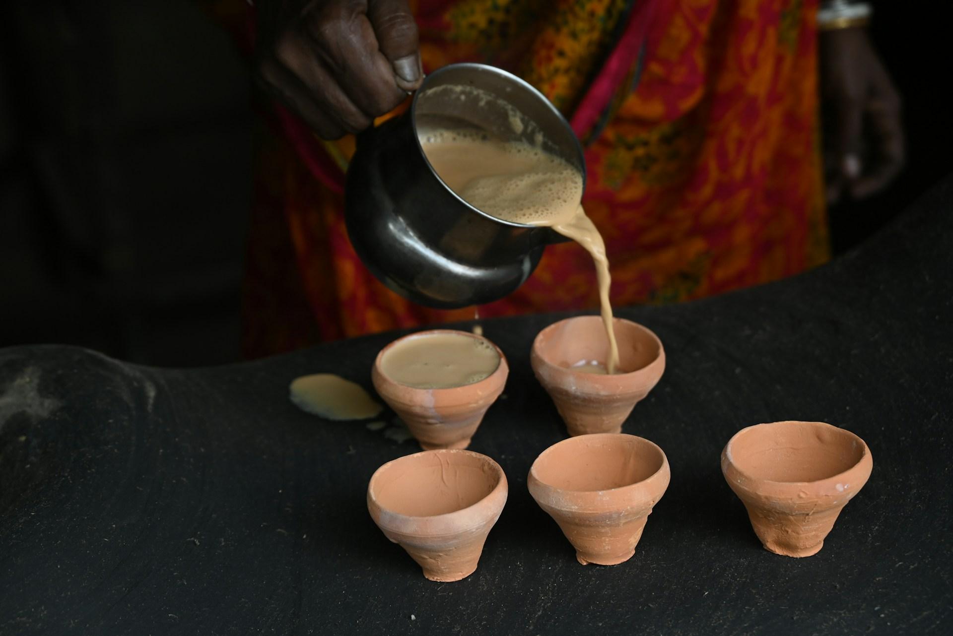 Pouring chai into clay cups