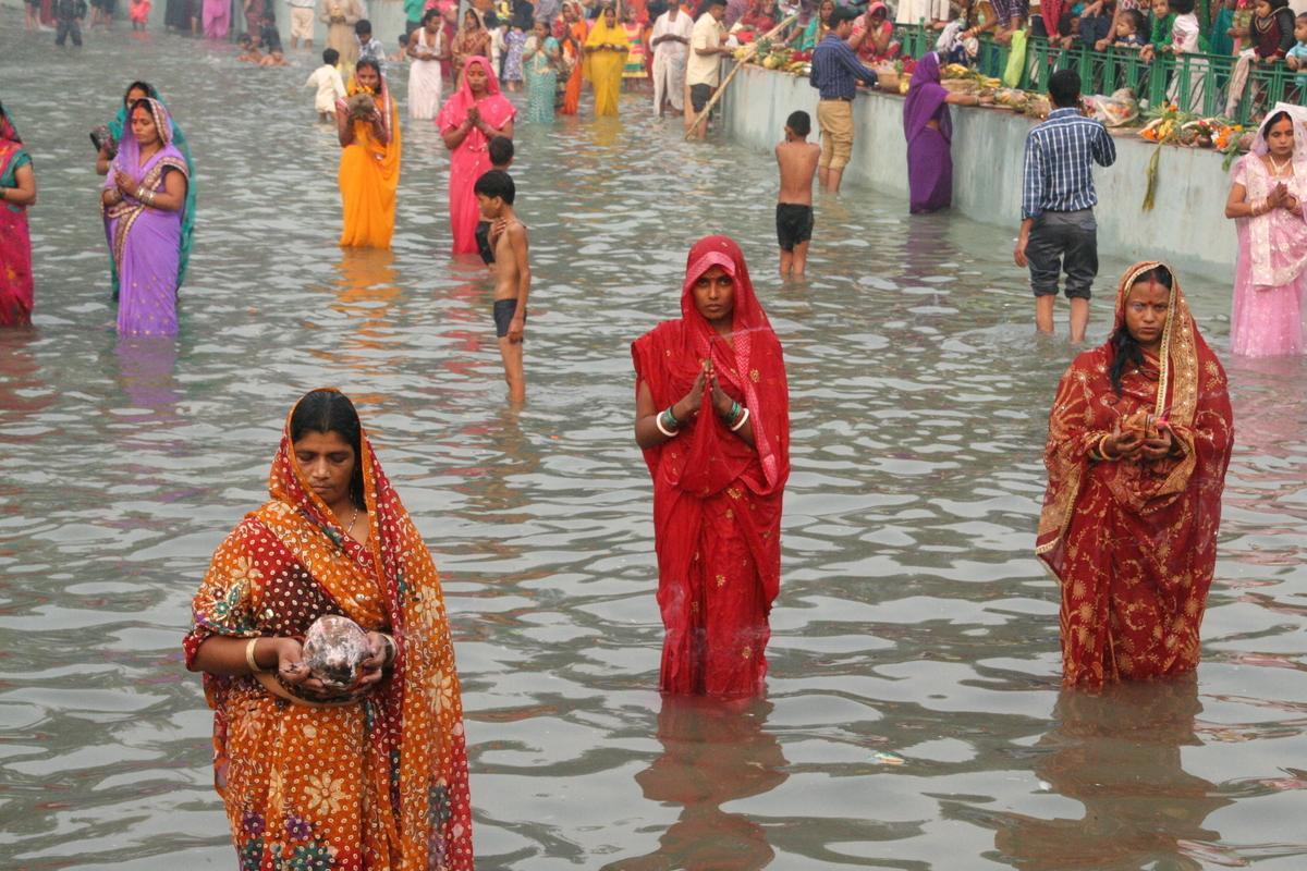Devotees standing in water