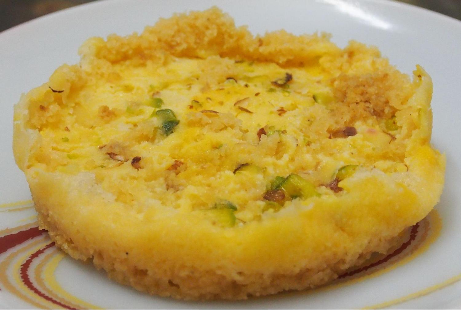 Malai Ghevar garnished with almonds
