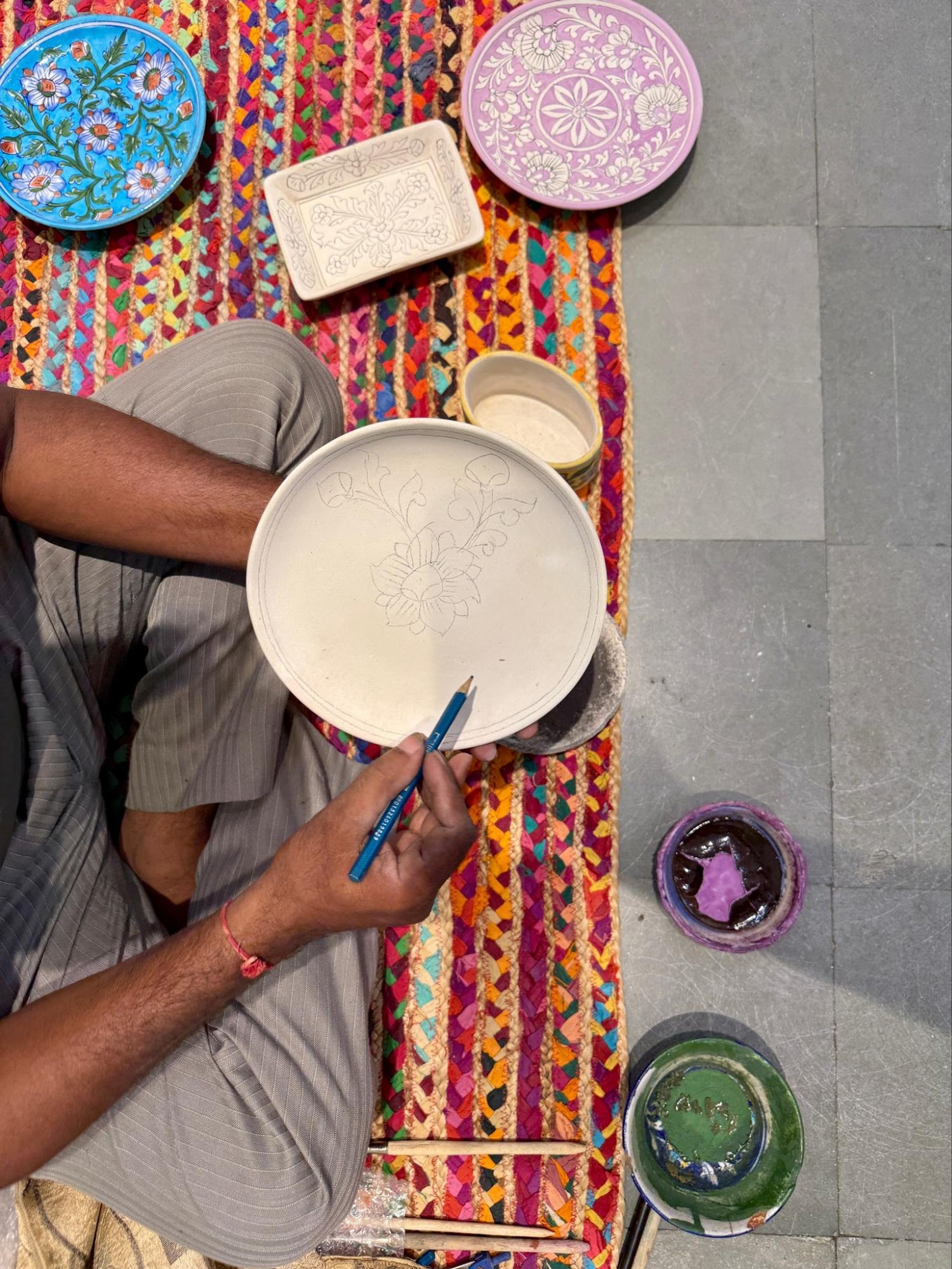 Artisan hand coloring a plate
