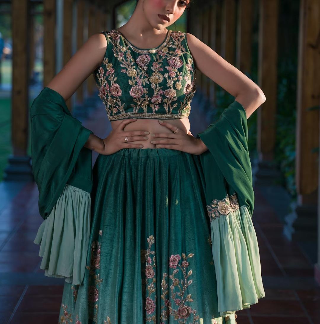 Woman in ornate green dress with dramatic
