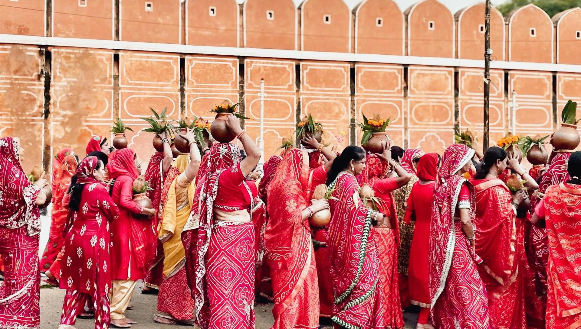 Group of women wearing red saris
