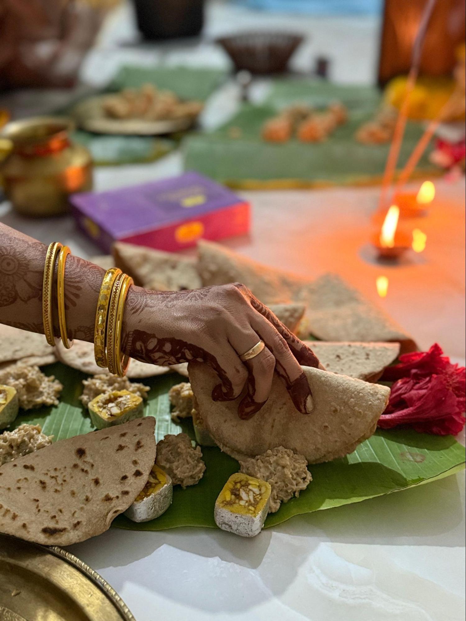 Devotee arranging kharna prasad on banana leaf