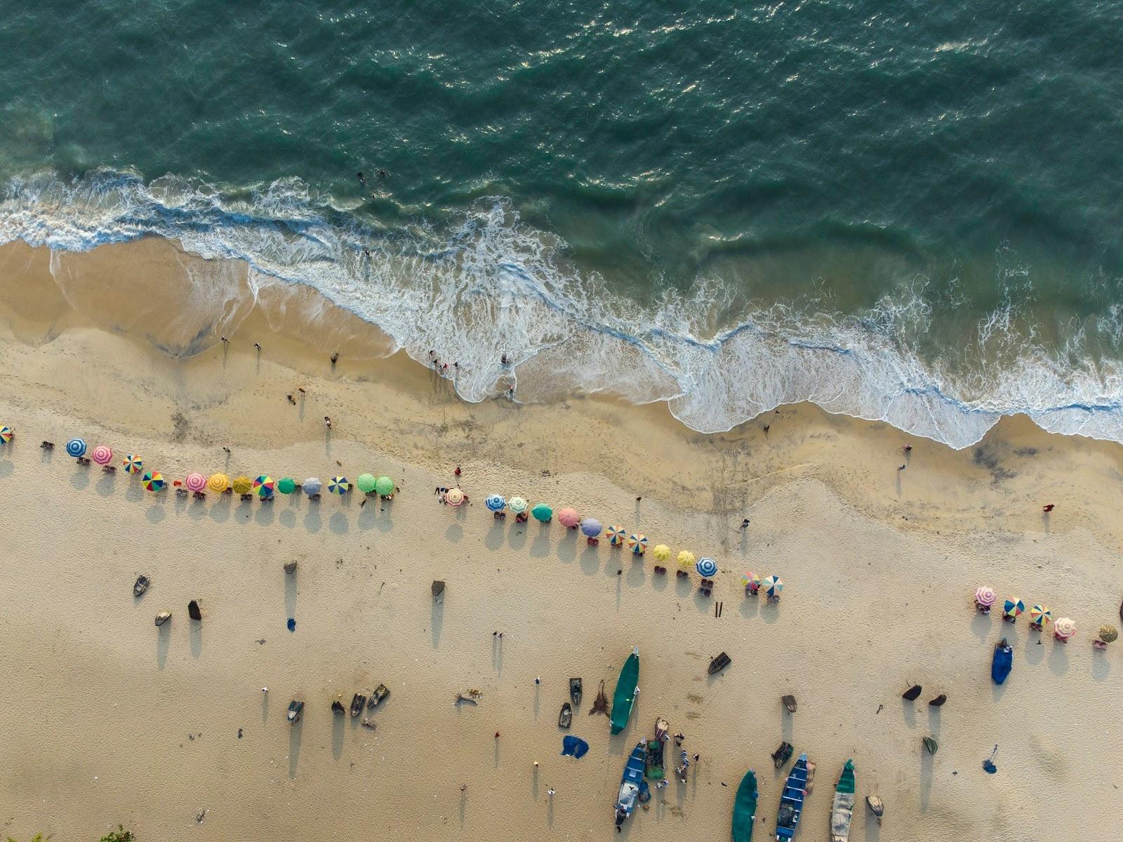 Group of people standing on sandy beach