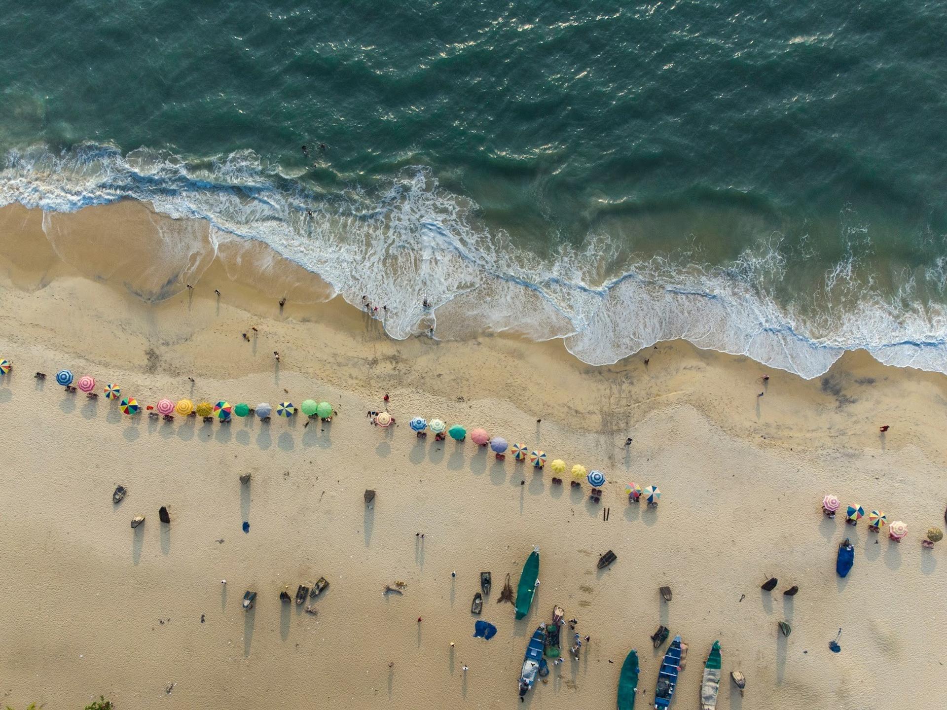 Group of people standing on sandy beach