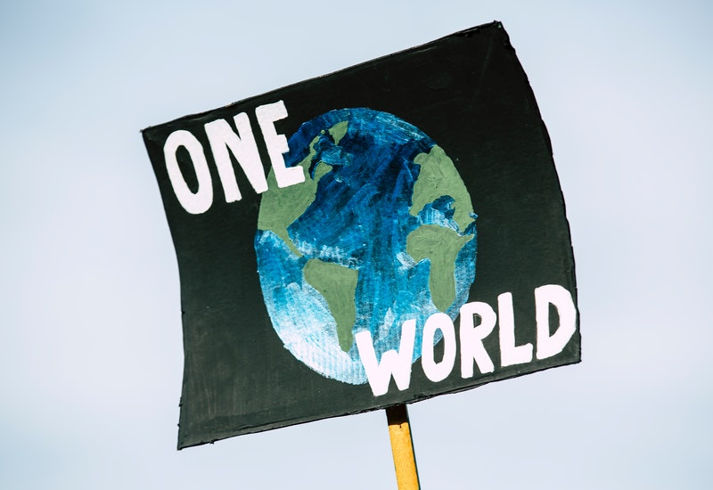 'One World' banner during climate protest