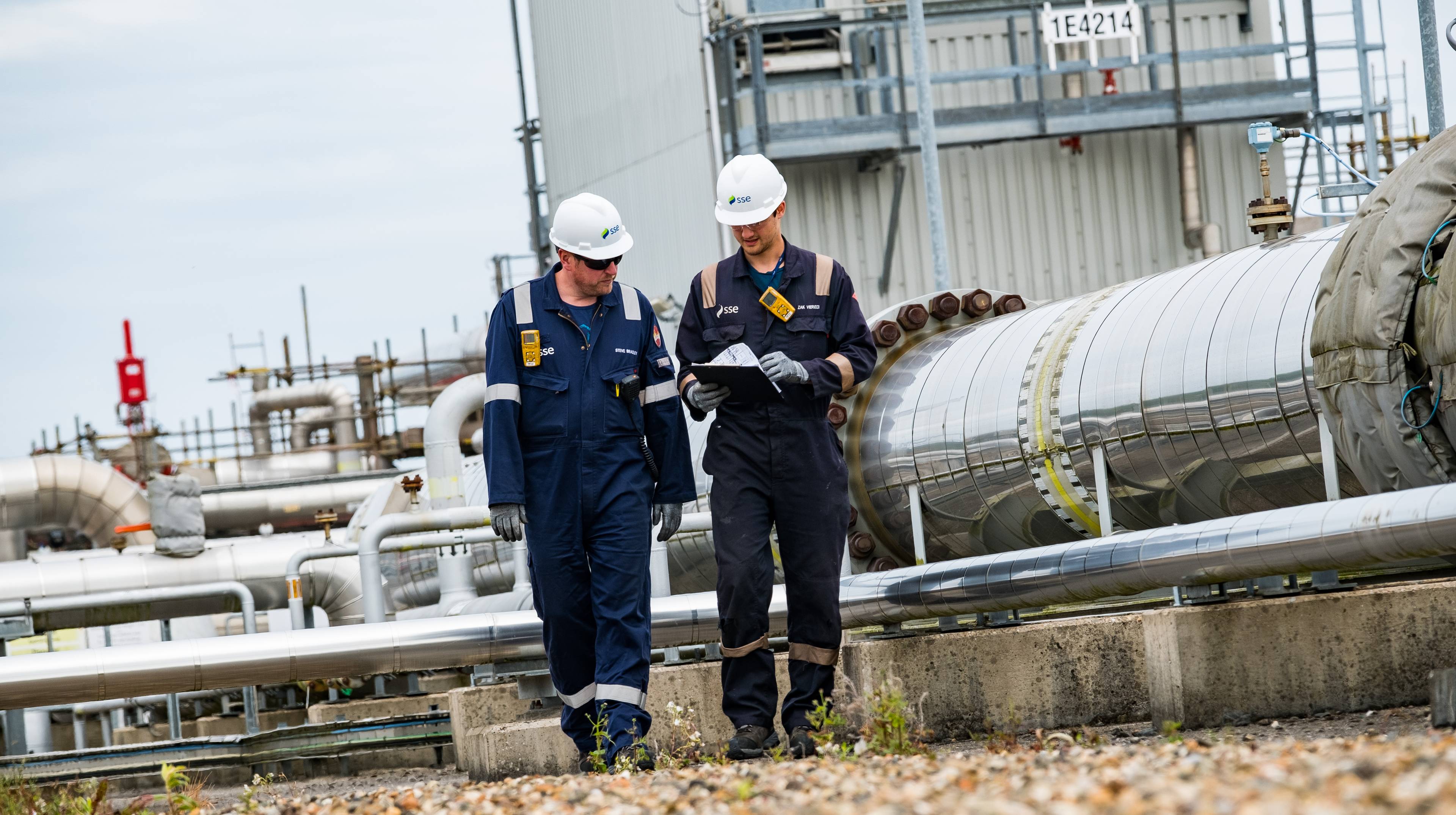 Two employees at the Aldbrough gas storage facility - processing facility in the background