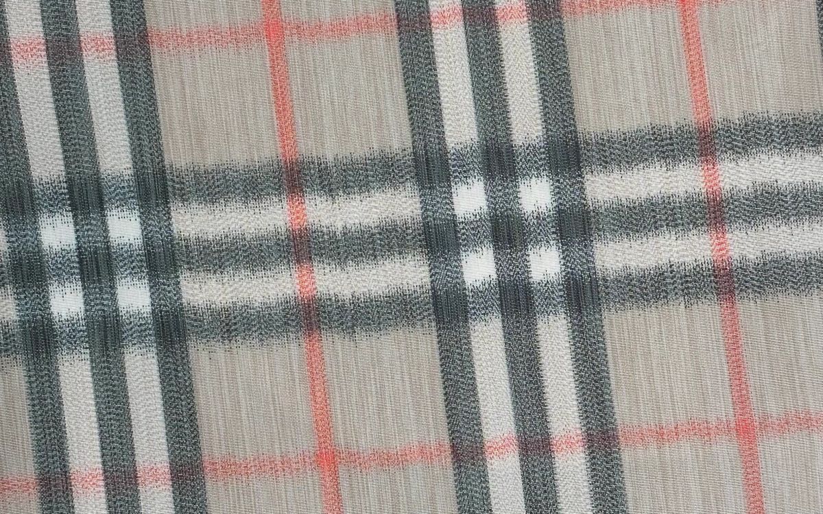 Close-up of the Burberry Check fabric weave, showing the camel, black, red, and white pattern