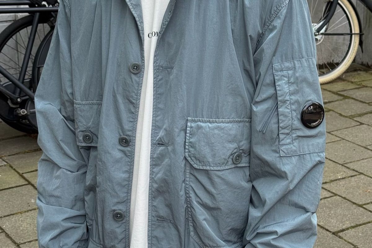 C.P. Company Chrome-R bomber jacket showing the round lens badge on the sleeve