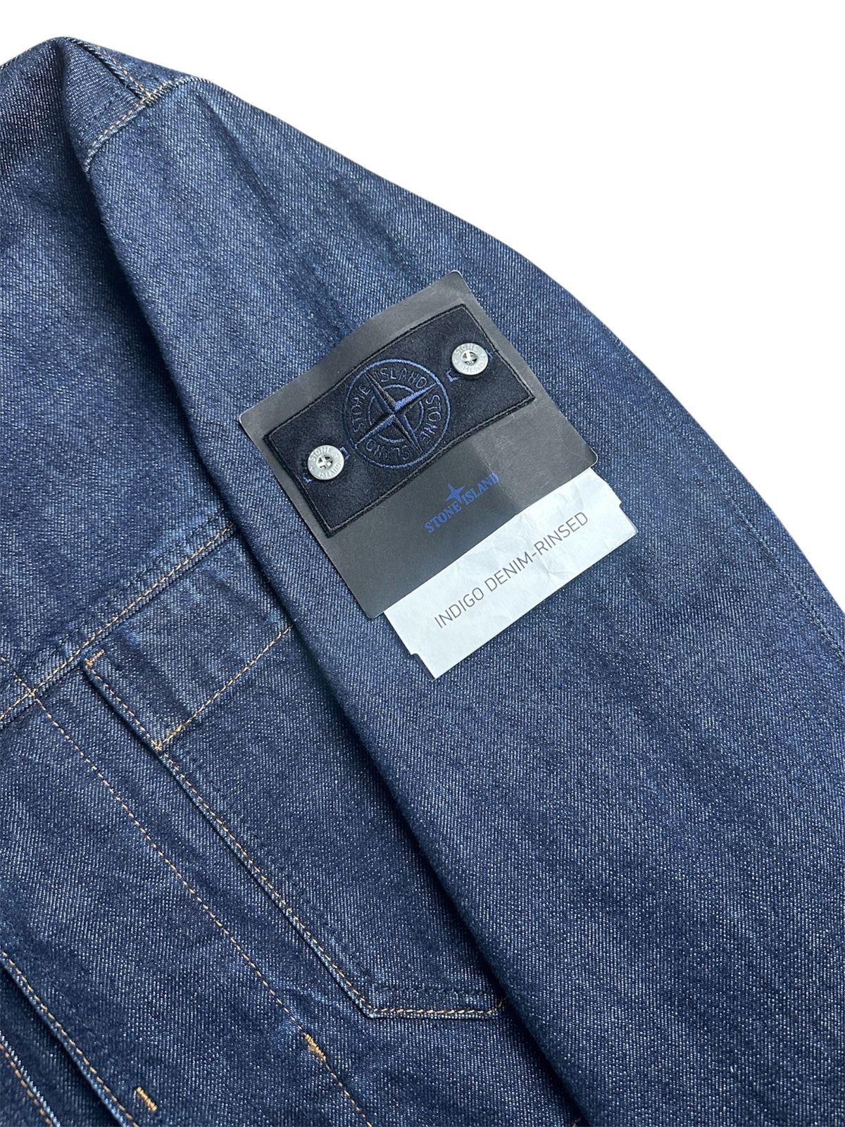Close-up of the Stone Island compass badge on a jacket sleeve