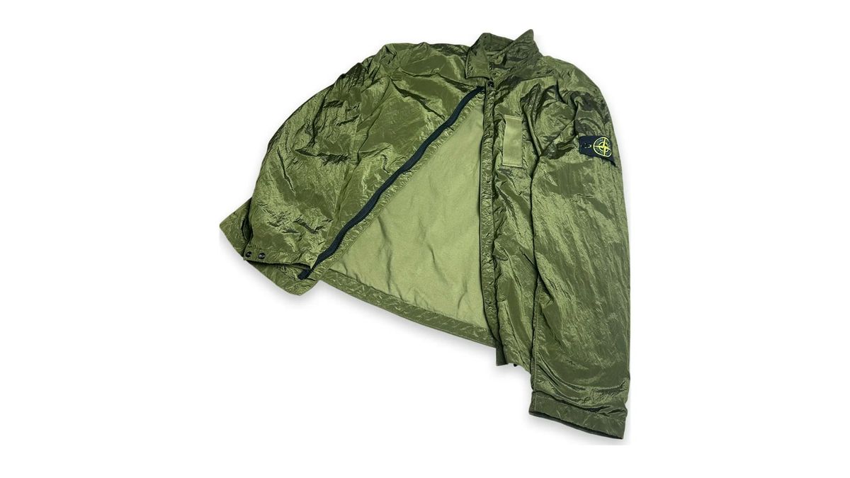 Stone Island Nylon Metal overshirt in green, showing the reflective metallic-thread fabric surface