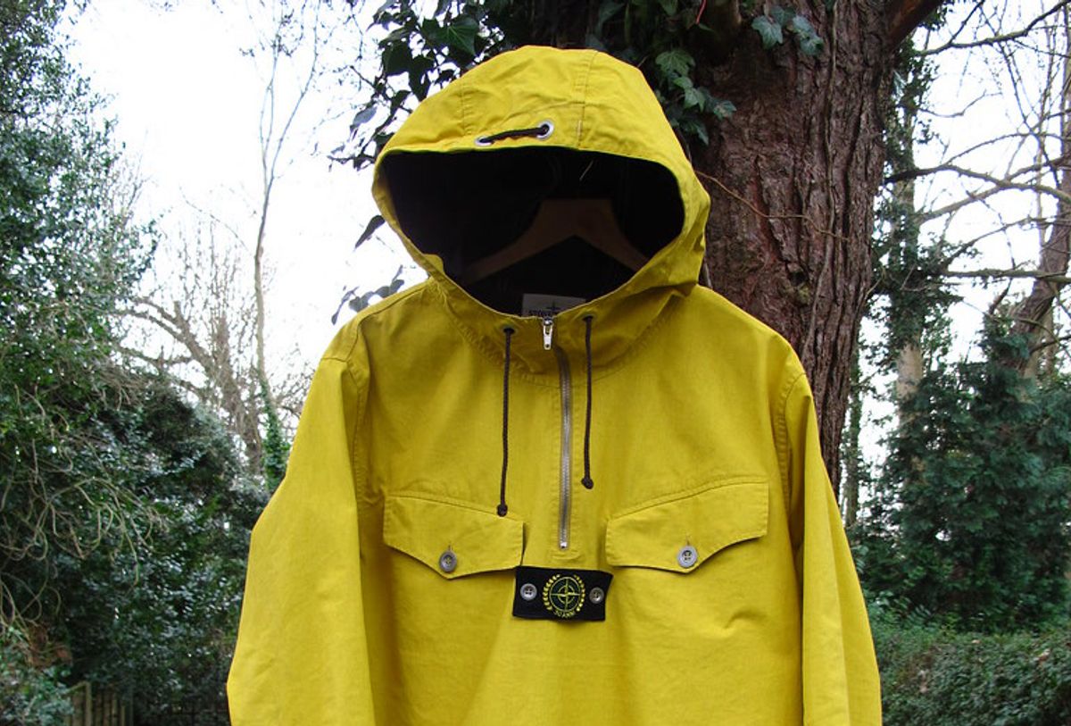 A 1982 Stone Island Tela Stella anorak in yellow, showing the original resin-coated stone-washed canvas