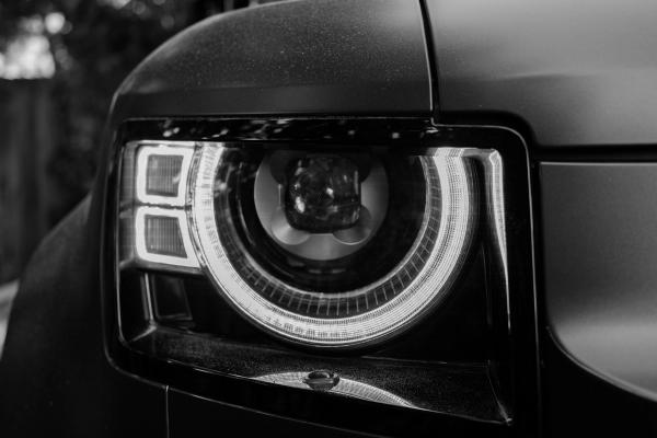 Land Rover Defender headlight with the signature halo daytime running light fully illuminated.
