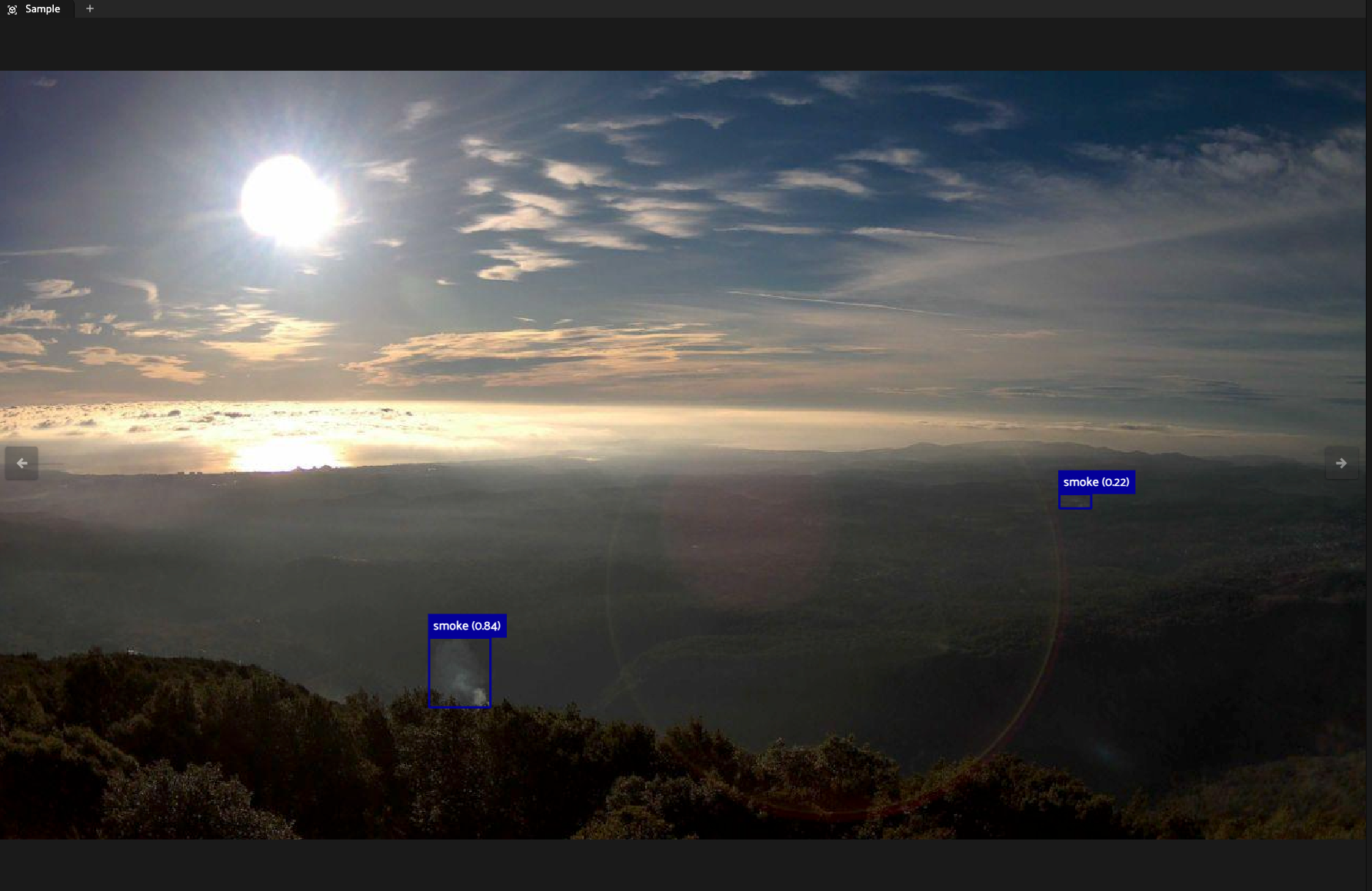 FiftyOne sample view of a wildfire camera frame showing two Pyronear model smoke detections with confidence scores and no corresponding ground truth annotations, flagging them as candidate missing labels.