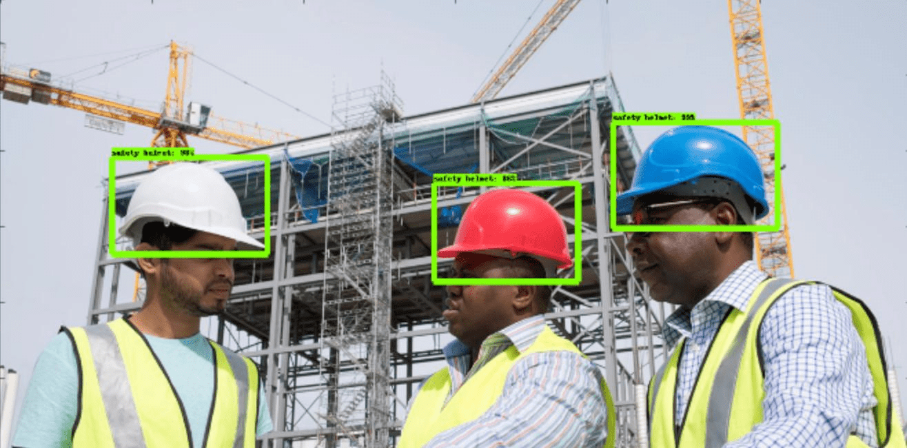 Three construction workings on a job site, with their hard hats being analyised by cv safety system
