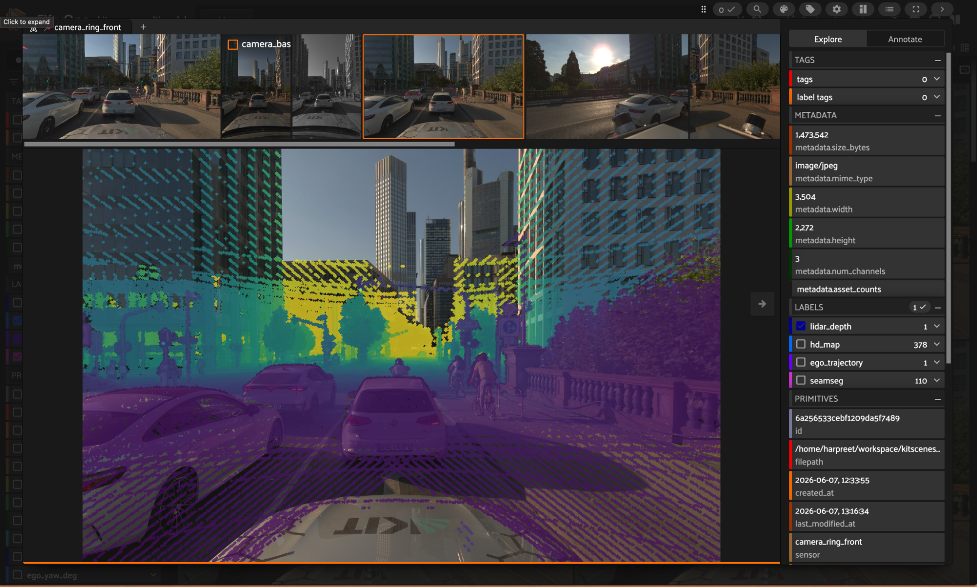 The lidar_depth heatmap on camera_ring_front, near-to-far depth fused from all seven lidars and projected into the image, with near returns in yellow and far in purple.