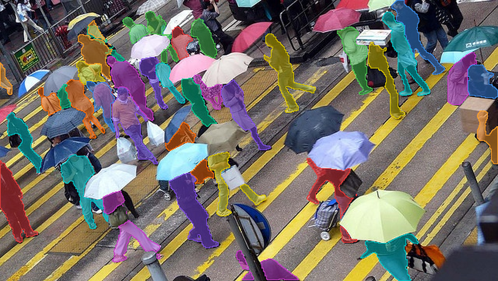 SAM 3 segmentation masks covering every pedestrian in a crowded crosswalk, each person highlighted in a different color from a single concept prompt.