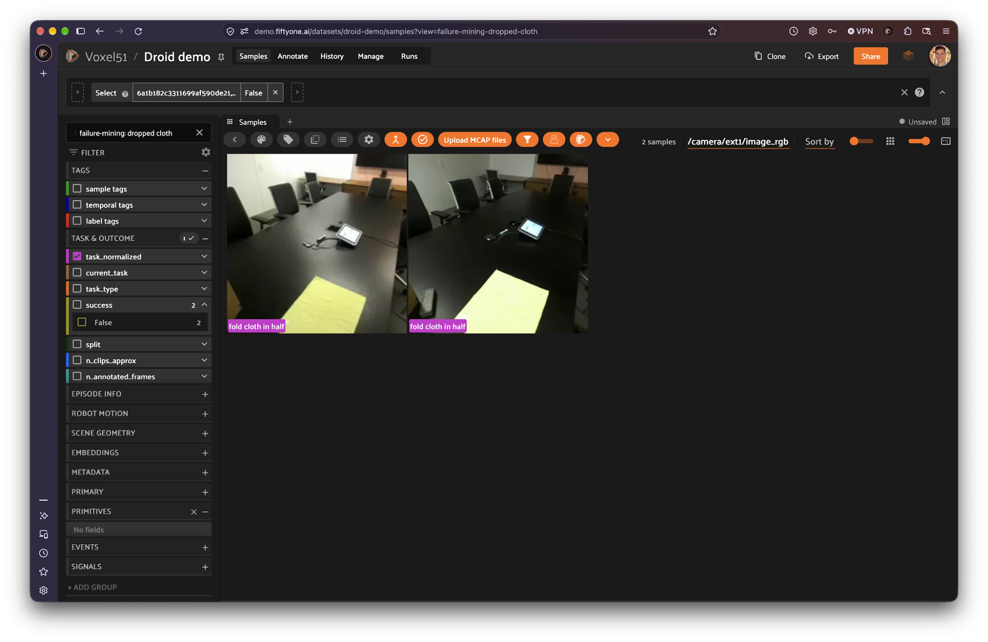 Saved view named "failure-mining: dropped cloth" showing two fold cloth in half episodes, with the sidebar's success field showing False for both.