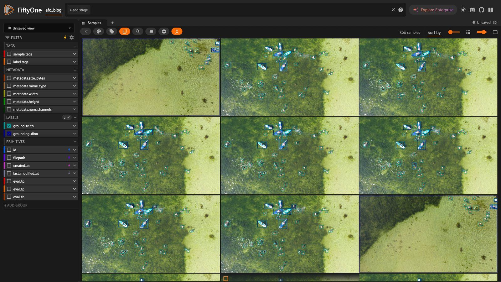 Aerial drone imagery from a maritime search-and-rescue dataset, viewed in the FiftyOne App. Teal boxes are ground truth, and blue boxes are predictions from a zero-shot detector. Even at a glance, the actual targets (people, paddleboards) are a tiny fraction of each frame.