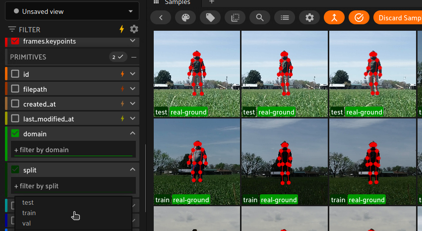 FiftyOne sidebar filtering the gesture dataset by domain and split, with real-ground clips showing pose skeletons overlaid in red.