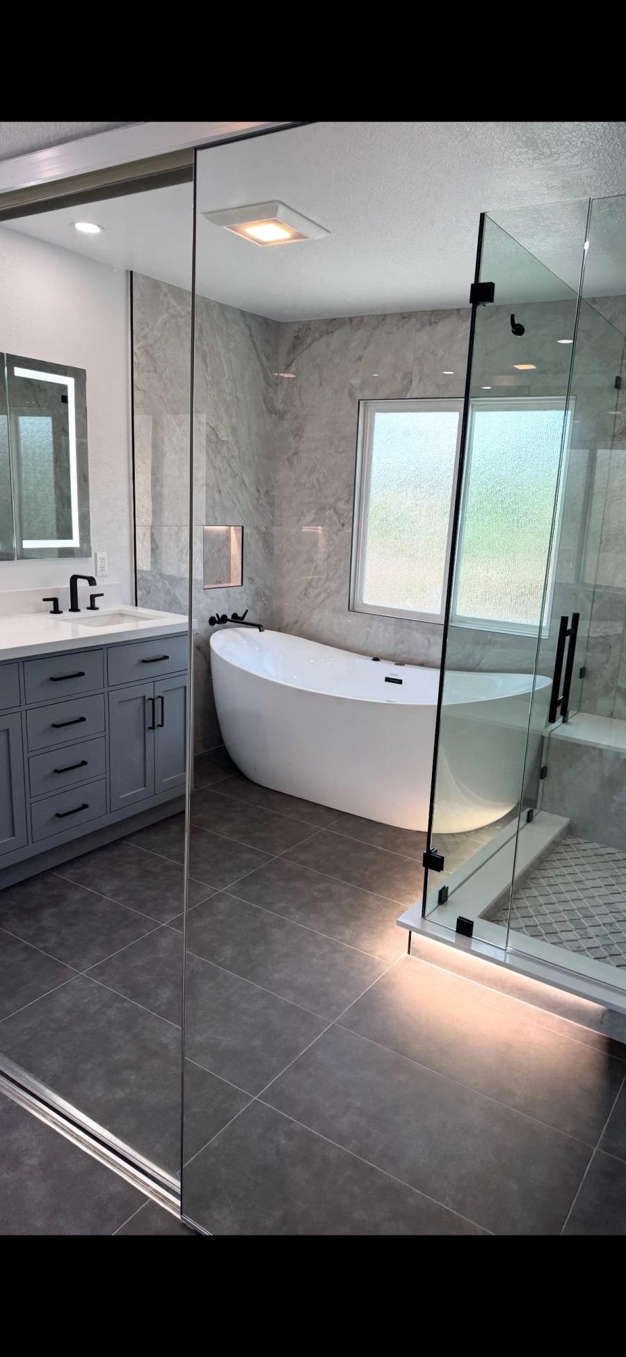 Modern bathroom remodel with freestanding tub and glass shower