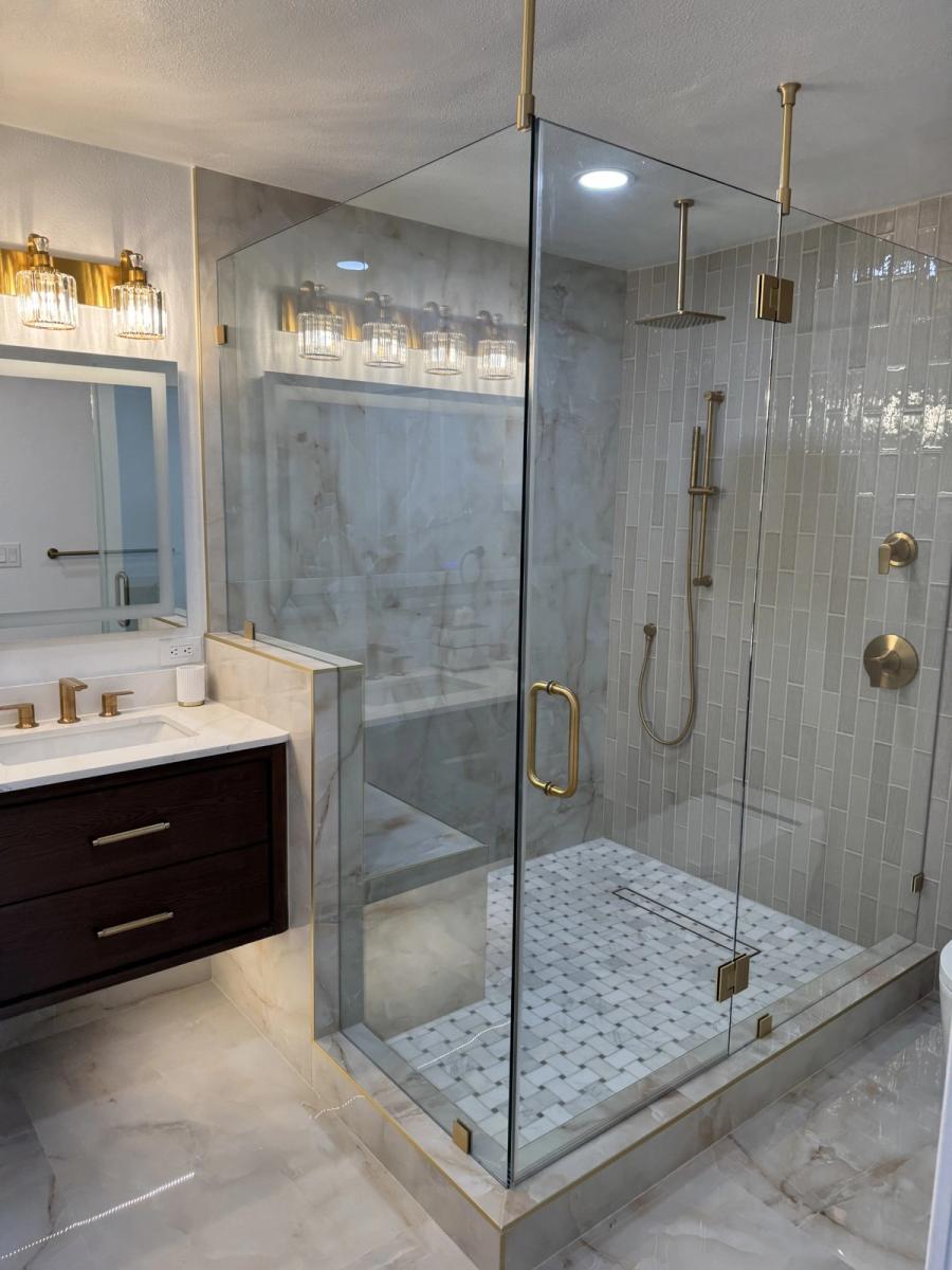 Luxury bathroom remodel with glass shower enclosure and marble tile