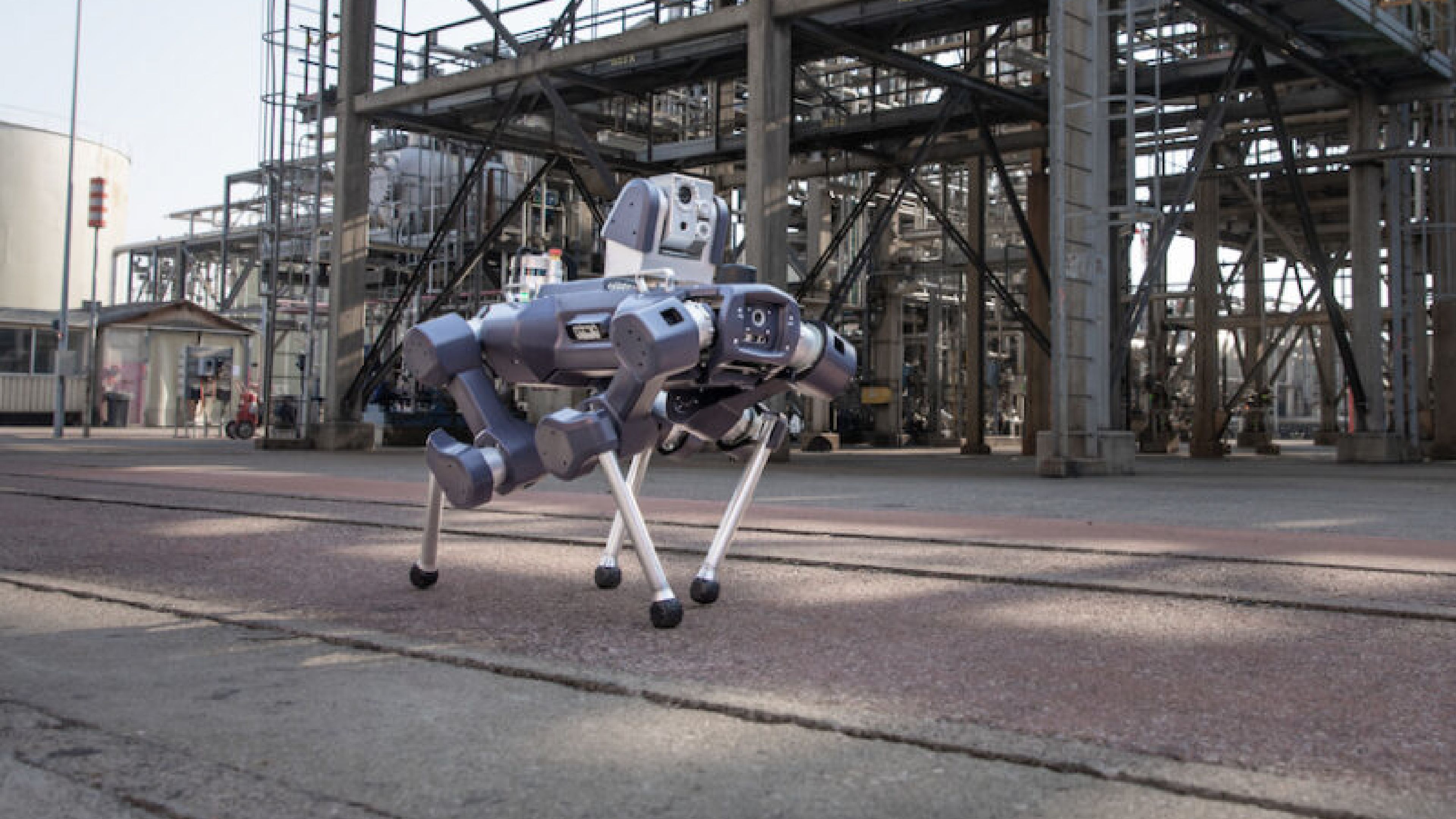 ANYbotics' ANYmal X quadruped inspection robot walks through an industrial facility.