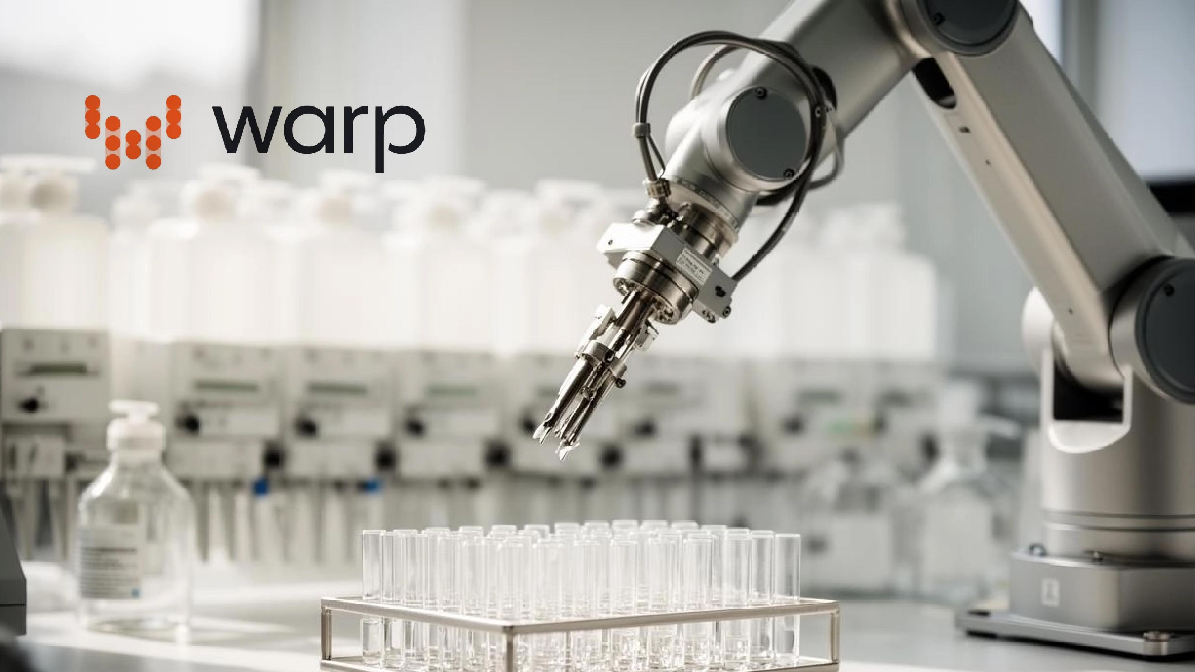A robotic arm positioned above rows of laboratory test tubes, with the Warp Sciences logo in the upper left corner.