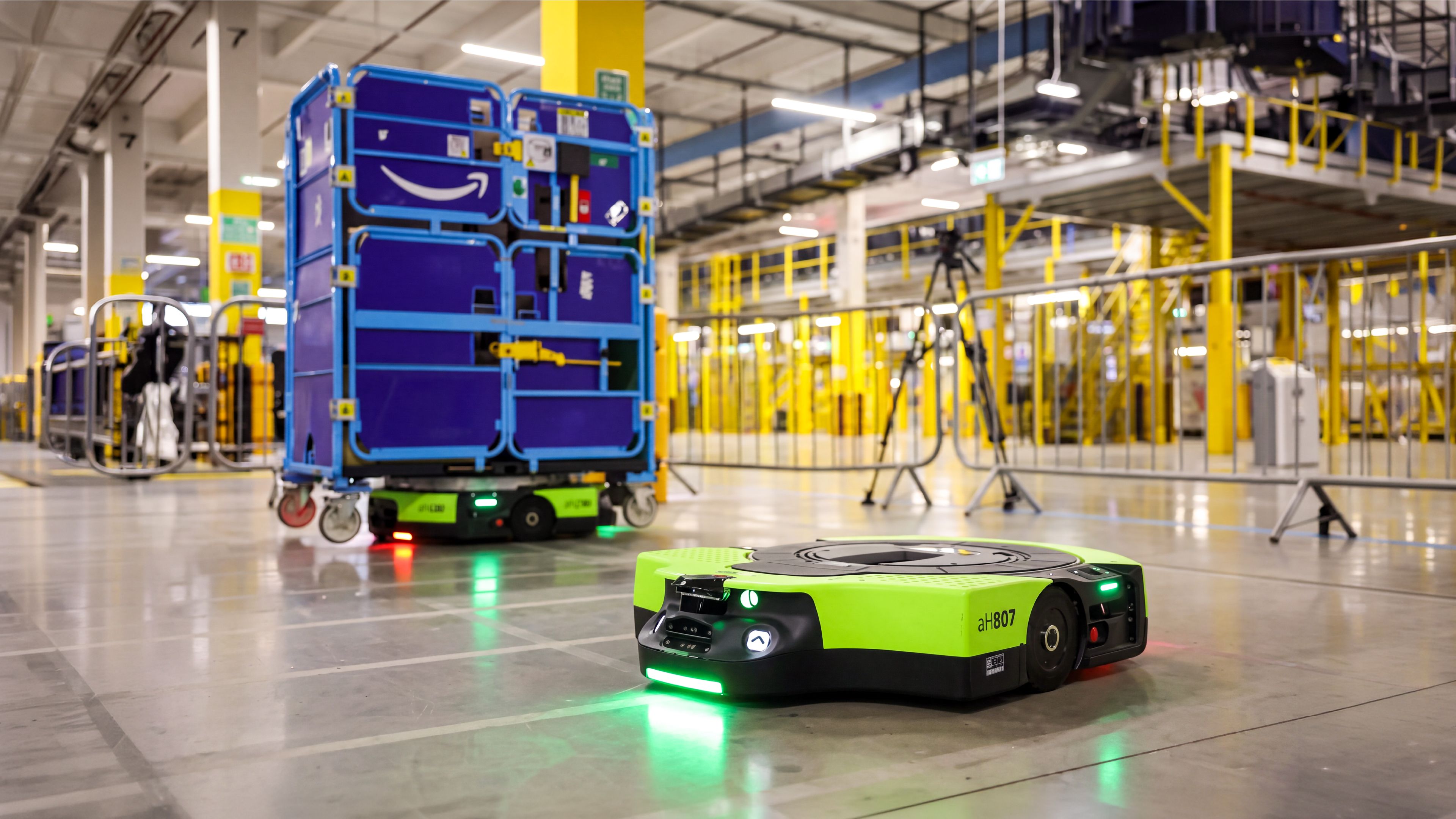 Autonomous mobile robots moving stock containers in an Amazon fulfilment centre