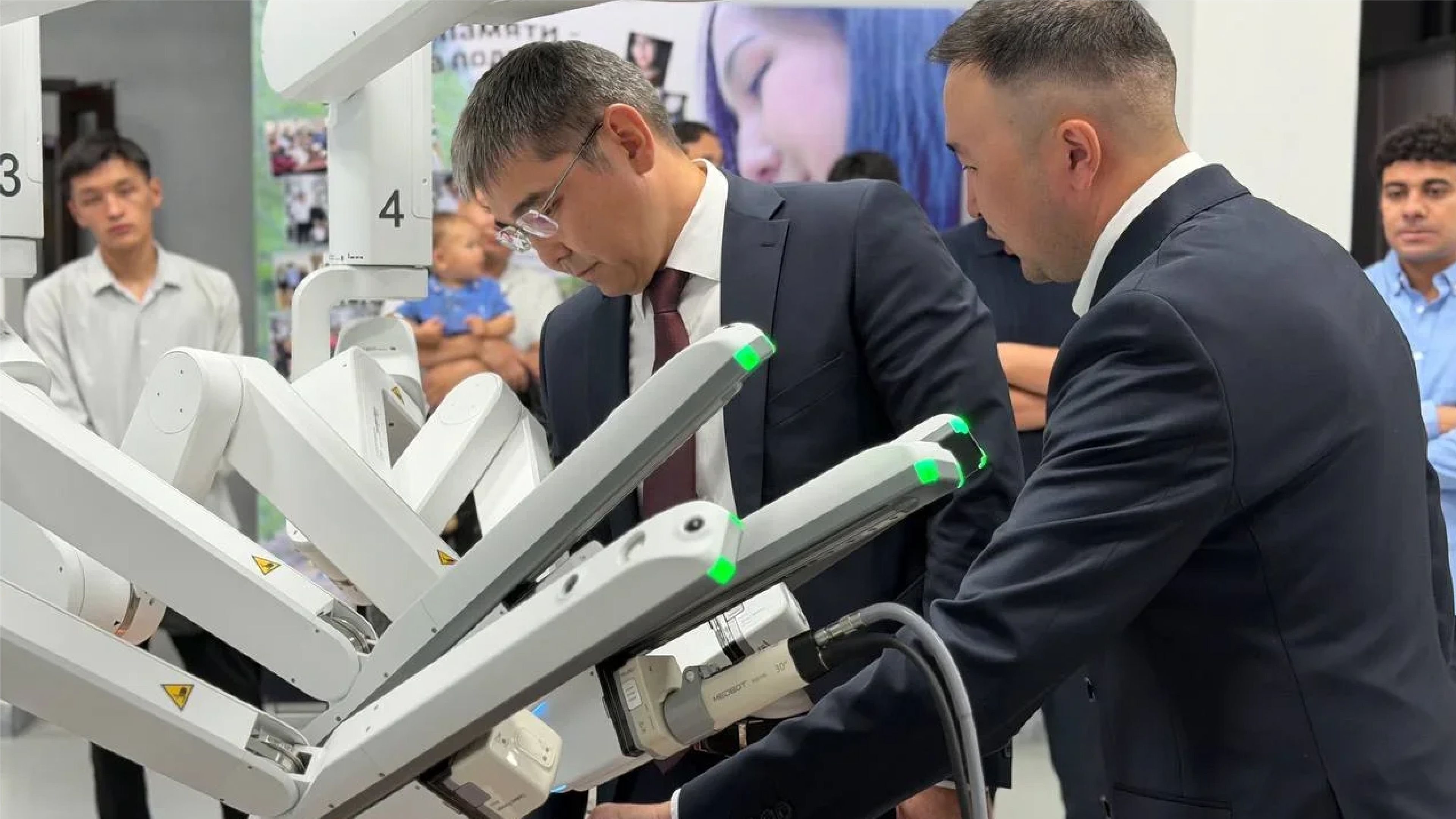 Officials inspect the robotic arms of a MicroPort MedBot Toumai surgical system during its presentation at the Kyrgyz State Medical Academy in Bishkek.