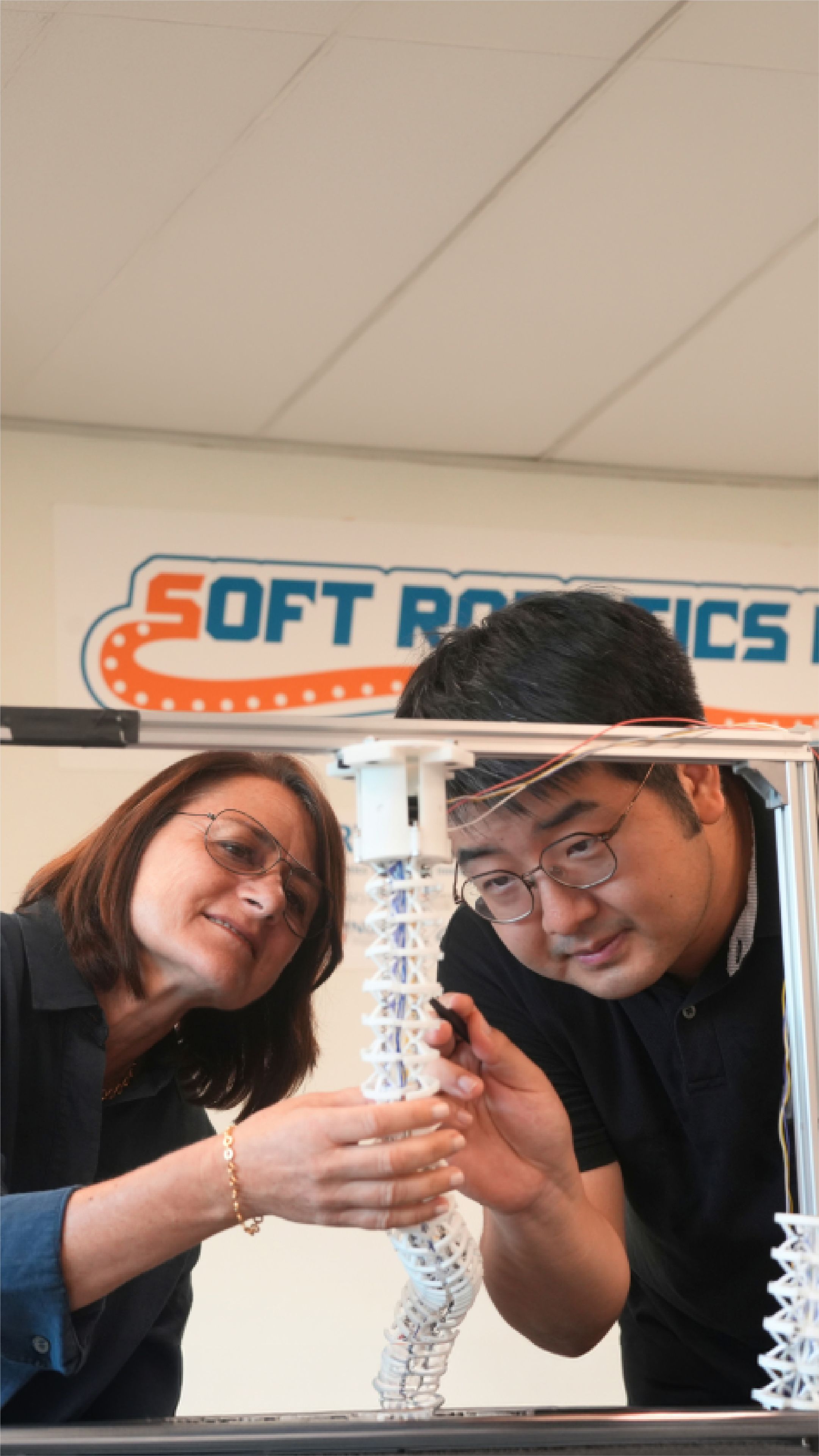 Researchers examine an octopus-inspired soft robotic arm prototype at the National University of Singapore’s Soft Robotics Lab.