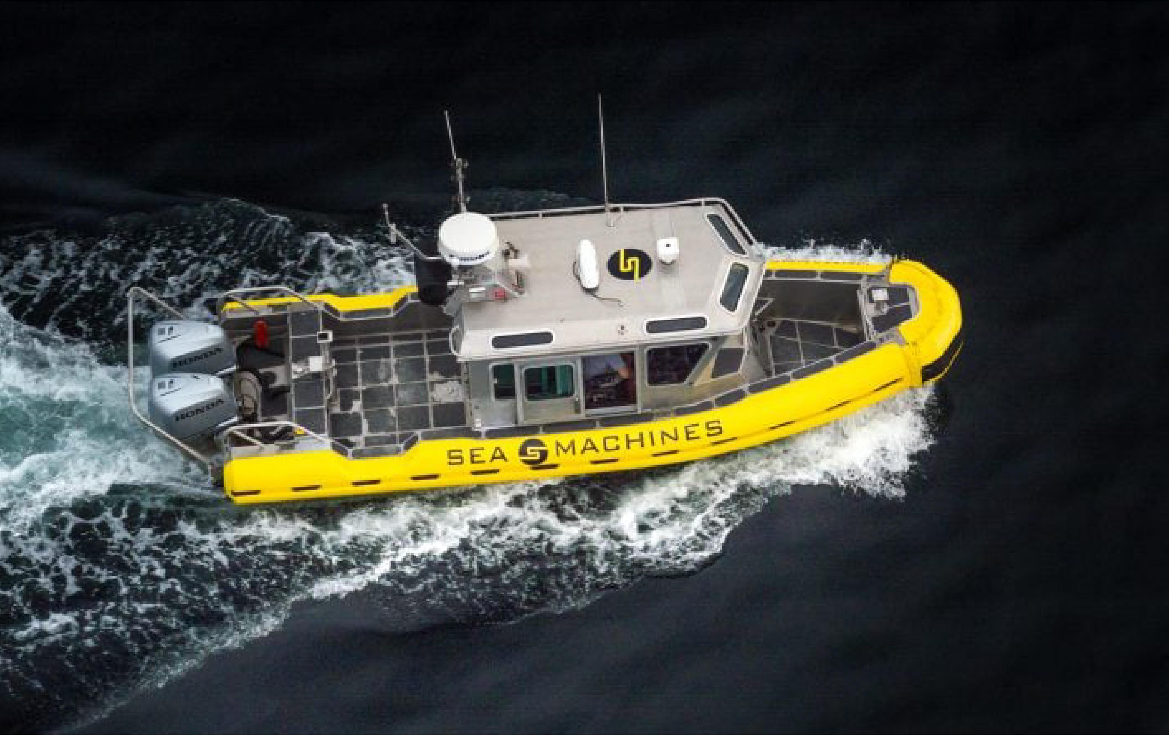 A yellow Sea Machines vessel travels across dark water.