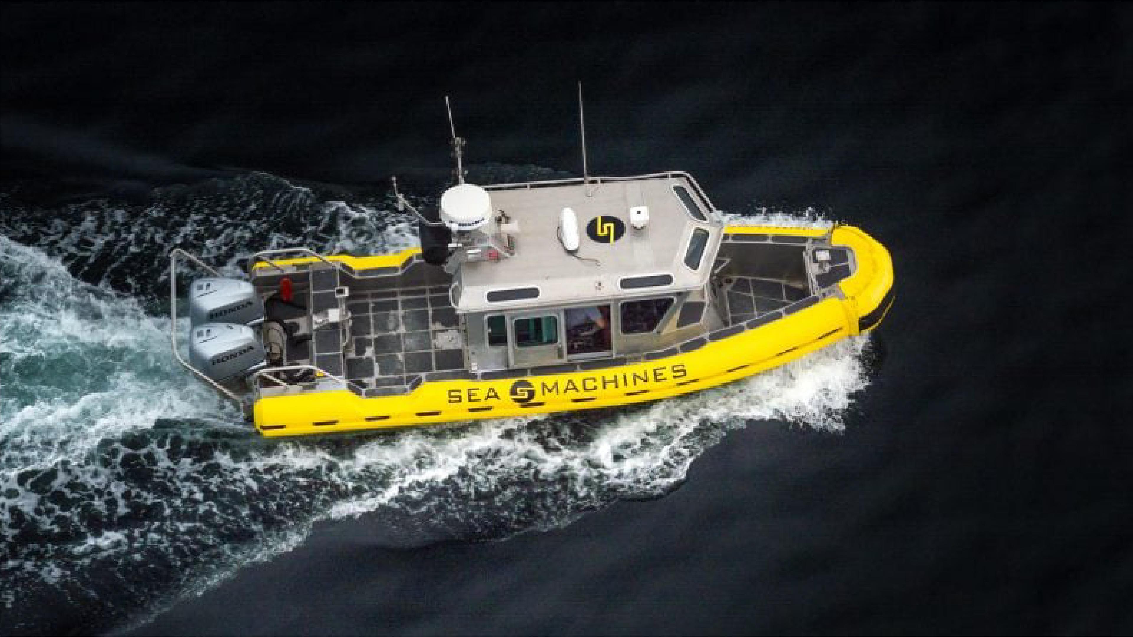 A yellow Sea Machines vessel travels across dark water.