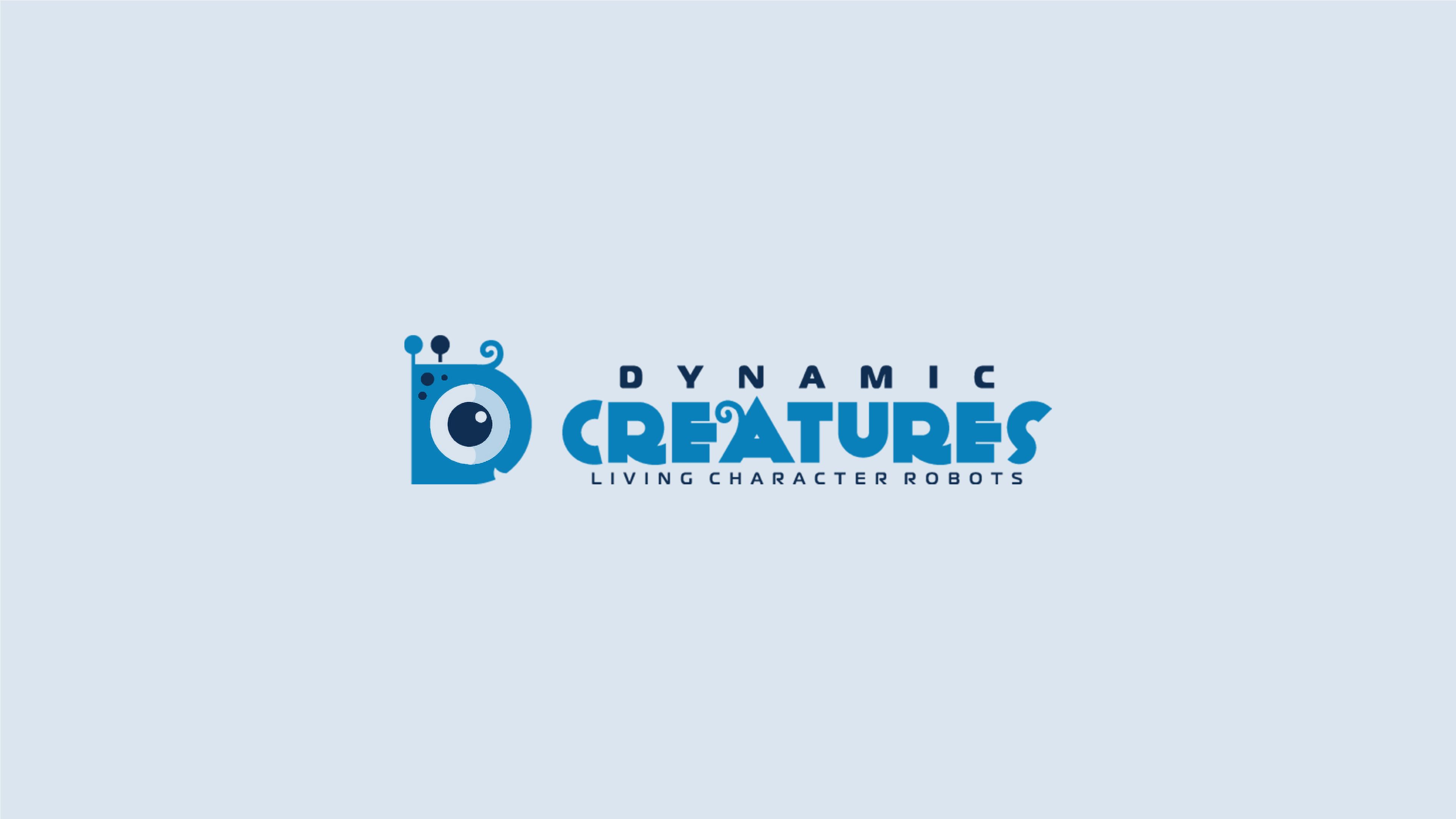 Logo for Dynamic Creatures, "Living Character Robots," featuring a stylized letter D shaped like a blue robotic creature with a single large eye, antennae and a curled tail, next to the company name in blue and navy lettering.