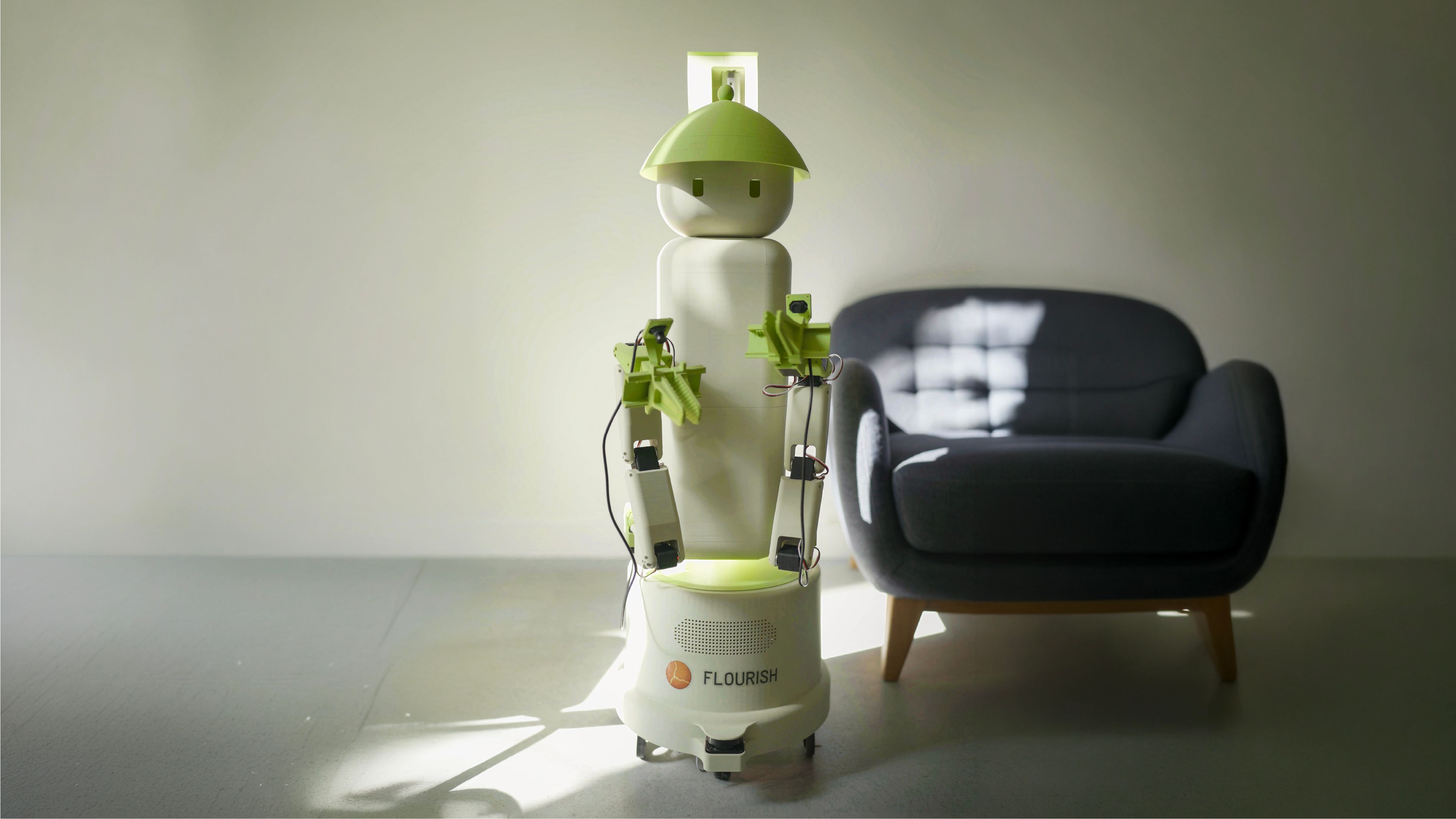Flourish home robot standing in a living room with its dual arms and grippers visible.